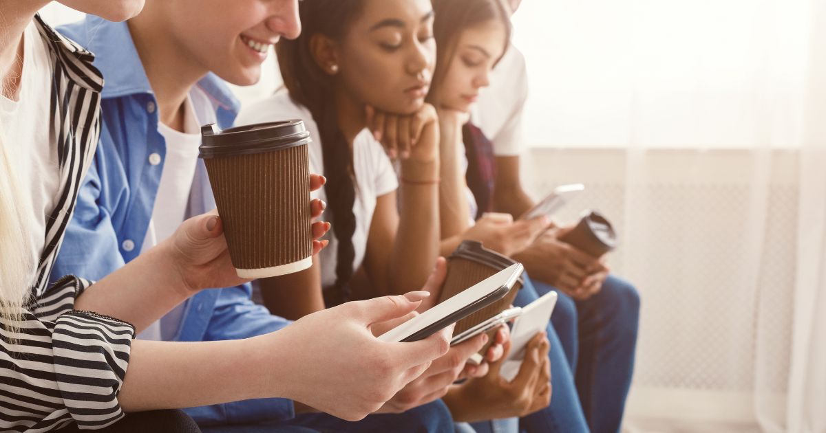 Teenagers using their smartphones